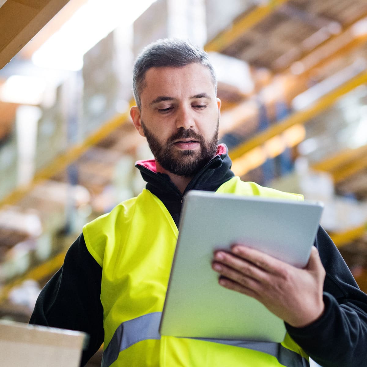 Warehouse worker reviewing data on a tablet