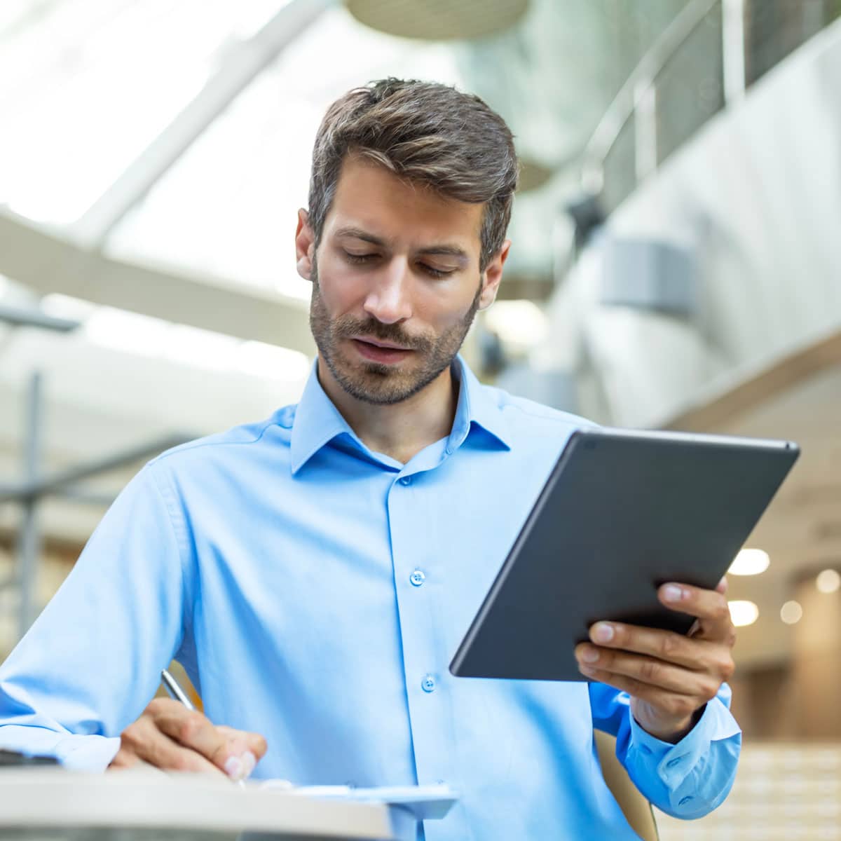 Man reviewing information on a tablet in an office