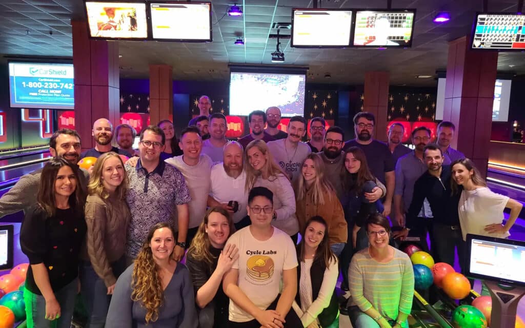 about-slider-4 Cycle Labs team group photo at a bowling alley